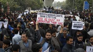 Protesters hold placards against the Citizenship Amendment Act (CAA) and the police crackdown on students, outside Jamia Millia Islamia, Maulana Mohammad Ali Jauhar Marg, in New Delhi, on Monday, December 16, 2019.(Burhaan Kinu/HT PHOTO) Protesters hold placards against the Citizenship Amendment Act (CAA) and the police crackdown on students, outside Jamia Millia Islamia, Maulana Mohammad Ali Jauhar Marg, in New Delhi, on Monday, December 16, 2019.(Burhaan Kinu/HT PHOTO)