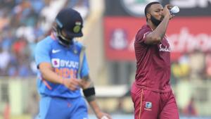 West Indies' captain Kieron Pollard, right, drinks water as he watches India's captain Virat Kohli after dismissing him for a duck(AP) West Indies' captain Kieron Pollard, right, drinks water as he watches India's captain Virat Kohli after dismissing him for a duck(AP)