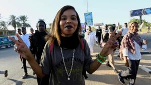 A Sudanese woman flashes a victory sign as people gather during the first anniversary of the start of the uprising that toppled long-time ruler Omar al-Bashir, in Khartoum, Sudan December 19.(REUTERS) A Sudanese woman flashes a victory sign as people gather during the first anniversary of the start of the uprising that toppled long-time ruler Omar al-Bashir, in Khartoum, Sudan December 19.(REUTERS)