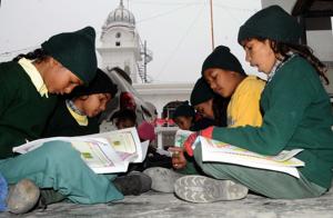 Students of Government Elementary School, Deep Nagar, braving the biting cold as they study on premises of Gurdwara New Bishan Nagar in Patiala on Monday.(BHARAT BHUSHAN/HT) Students of Government Elementary School, Deep Nagar, braving the biting cold as they study on premises of Gurdwara New Bishan Nagar in Patiala on Monday.(BHARAT BHUSHAN/HT)
