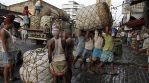 Indian laborers carry a giant basket of vegetables to a wholesale market in Kolkata, India. Image for representation(AP file photo) Indian laborers carry a giant basket of vegetables to a wholesale market in Kolkata, India. Image for representation(AP file photo)