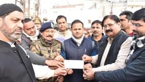 Muslims in Bulandshahr handing over a Demand Draft to compensate the damages to property in anti-CAA protests.(HT Photo) Muslims in Bulandshahr handing over a Demand Draft to compensate the damages to property in anti-CAA protests.(HT Photo)