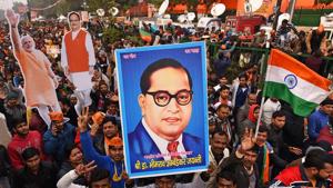A BJP supporter holds up an image of Dr. BR Ambedkar during Prime Minister Narendra Modi's rally at Ramlila Maidan in New Delhi on December 22.(HT PHOTO) A BJP supporter holds up an image of Dr. BR Ambedkar during Prime Minister Narendra Modi's rally at Ramlila Maidan in New Delhi on December 22.(HT PHOTO)
