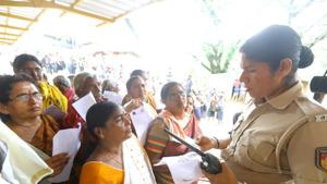 A police personnel checks the age proof of women devotees to weed out women in the 10-50 age group at the Pamba base camp of Sabarimala Temple.(HT Photo) A police personnel checks the age proof of women devotees to weed out women in the 10-50 age group at the Pamba base camp of Sabarimala Temple.(HT Photo)