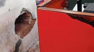 The hole in the wall of a post office in east Delhi’s Mansarovar Park area. The suspect is absconding, police said.(Sourced)