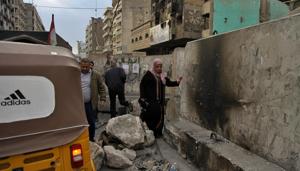 People pass concrete barriers set by security forces to block anti-government protesters, in Baghdad, Iraq, Wednesday, Jan. 8, 2020.(AP file photo) People pass concrete barriers set by security forces to block anti-government protesters, in Baghdad, Iraq, Wednesday, Jan. 8, 2020.(AP file photo)
