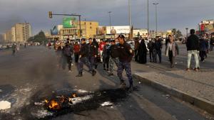 Security forces try to open streets while protesters set fire during a demonstration to protest against the Iranian missile strike at two military bases in Iraq that house American troops , in Baghdad, Iraq, Wednesday, Jan. 8, 2020(AP) Security forces try to open streets while protesters set fire during a demonstration to protest against the Iranian missile strike at two military bases in Iraq that house American troops , in Baghdad, Iraq, Wednesday, Jan. 8, 2020(AP)