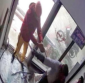 A CCTV grab showing two of the three robbers armed with a countrymade pistol and(HT PHOTO) A CCTV grab showing two of the three robbers armed with a countrymade pistol and(HT PHOTO)