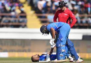 Indian batsman Shikhar Dhawan lies on the ground after being hit by the ball as Rohit Sharma watch during the second one day international (ODI) cricket match between India and Australia at Saurashtra Cricket Association Stadium in Rajkot, Friday, Jan. 17, 2020.(PTI) Indian batsman Shikhar Dhawan lies on the ground after being hit by the ball as Rohit Sharma watch during the second one day international (ODI) cricket match between India and Australia at Saurashtra Cricket Association Stadium in Rajkot, Friday, Jan. 17, 2020.(PTI)