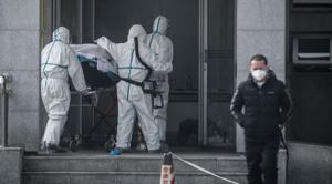 Medical staff members carry a patient into the Jinyintan hospital, where patients infected by a mysterious SARS-like virus are being treated, in Wuhan in China's central Hubei province on January 18, 2020.(AFP)