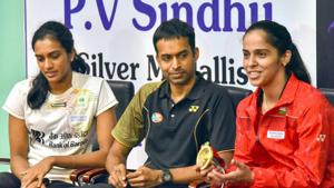Indian badminton coach P Gopichand with PV Sindhu andSaina Nehwal.(PTI) Indian badminton coach P Gopichand with PV Sindhu andSaina Nehwal.(PTI)