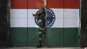 An Indian Border Security Force soldier walks through a gate painted with the Indian flag at the India-Pakistan border at Suchet Garh in Ranbir Singh Pura, about 27 kilometers south of Jammu.(AP) An Indian Border Security Force soldier walks through a gate painted with the Indian flag at the India-Pakistan border at Suchet Garh in Ranbir Singh Pura, about 27 kilometers south of Jammu.(AP)