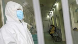 Wuhan: Medical workers in protective gear stand as a woman suspected of being ill with coronavirus waits to be seen at a community health station in Wuhan in central China's Hubei Province, Monday, Jan. 27, 2020.(AP) Wuhan: Medical workers in protective gear stand as a woman suspected of being ill with coronavirus waits to be seen at a community health station in Wuhan in central China's Hubei Province, Monday, Jan. 27, 2020.(AP)