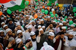 Demonstrators salute and wave an Indian flag during Republic Day celebrations at the site of a protest against a new citizenship law in Ahmedabad, India.(Photo: Reuters) Demonstrators salute and wave an Indian flag during Republic Day celebrations at the site of a protest against a new citizenship law in Ahmedabad, India.(Photo: Reuters)