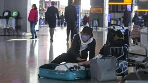 A woman wearing a face mask packs her suitcase in the departures area of Terminal 5, after it was announced British Airways has suspended all services to and from China, at London's Heathrow Airport on Wednesday.(AP Photo) A woman wearing a face mask packs her suitcase in the departures area of Terminal 5, after it was announced British Airways has suspended all services to and from China, at London's Heathrow Airport on Wednesday.(AP Photo)