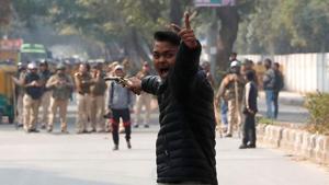 An unidentified man reacts as he brandishes a gun during a protest against amended citizenship law outside the Jamia Millia Islamia university in New Delhi on January 30, 2020.(REUTERS) An unidentified man reacts as he brandishes a gun during a protest against amended citizenship law outside the Jamia Millia Islamia university in New Delhi on January 30, 2020.(REUTERS)
