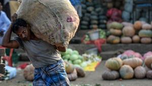A labourer carries a vegetable bag at a wholesale vegetable market in Chennai on February 1, 2020.(AFP photo) A labourer carries a vegetable bag at a wholesale vegetable market in Chennai on February 1, 2020.(AFP photo)