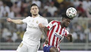 Real Madrid's Luka Jovic, left, fights for the ball with Atletico Madrid's Thomas Partey(AP)