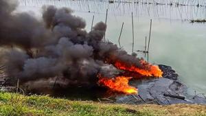 Plumes of smoke rise over a small stream of the Burhi Dihing River.(PTI) Plumes of smoke rise over a small stream of the Burhi Dihing River.(PTI)