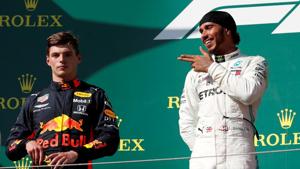 Mercedes' Lewis Hamilton gestures on the podium as he celebrates winning the Hungarian Grand Prix as Red Bull's Max Verstappen looks on.(REUTERS) Mercedes' Lewis Hamilton gestures on the podium as he celebrates winning the Hungarian Grand Prix as Red Bull's Max Verstappen looks on.(REUTERS)
