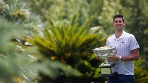 Australian Open champion Serbia's Novak Djokovic poses with the trophy during a photo shoot at the Royal Botanic Gardens Victoria.(REUTERS) Australian Open champion Serbia's Novak Djokovic poses with the trophy during a photo shoot at the Royal Botanic Gardens Victoria.(REUTERS)