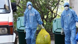 Medical staff fully covered with protective suits disposing of waste as they exit from a coronavirus isolated ward at Kochi Medical collage in Kerala.(ANI Photo) Medical staff fully covered with protective suits disposing of waste as they exit from a coronavirus isolated ward at Kochi Medical collage in Kerala.(ANI Photo)