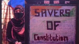 A signage with the words 'Savers of Constitution' is seen with a Muslim woman in the backdrop during Jashn-e-Ekta at Shaheen Bagh, a site of the ongoing protests against CAA, NRC and NPR in New Delhi.(Amal KS/HT PHOTO) A signage with the words 'Savers of Constitution' is seen with a Muslim woman in the backdrop during Jashn-e-Ekta at Shaheen Bagh, a site of the ongoing protests against CAA, NRC and NPR in New Delhi.(Amal KS/HT PHOTO)