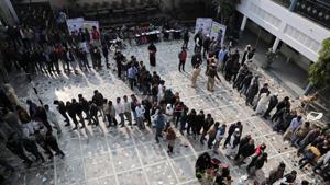 Voters stand in queues as they wait to cast their vote outside a polling booth during Delhi Assembly elections, in Shaheen Bagh, on February 8.(Reuters Photo) Voters stand in queues as they wait to cast their vote outside a polling booth during Delhi Assembly elections, in Shaheen Bagh, on February 8.(Reuters Photo)