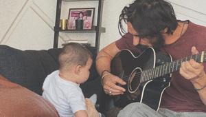 Arjun Rampal plays the guitar for his son Arik. Arjun Rampal plays the guitar for his son Arik.