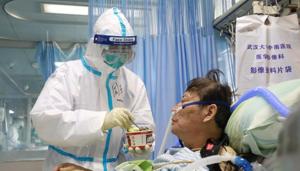 A nurse in a protective suit feeds a novel coronavirus patient inside an isolated ward at Zhongnan Hospital of Wuhan University, during the Lantern Festival, which marks the end of the Chinese Lunar New Year celebrations, in Wuhan, Hubei province, China February 8, 2020.(REUTERS) A nurse in a protective suit feeds a novel coronavirus patient inside an isolated ward at Zhongnan Hospital of Wuhan University, during the Lantern Festival, which marks the end of the Chinese Lunar New Year celebrations, in Wuhan, Hubei province, China February 8, 2020.(REUTERS)