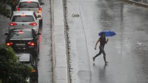 A pedestrian braves strong wind and rain in Sydney, New South Wales, Australia.(Reuters image) A pedestrian braves strong wind and rain in Sydney, New South Wales, Australia.(Reuters image)