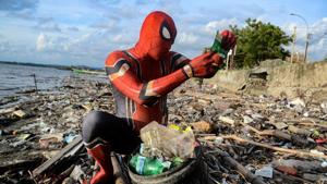 Rudi Hartono, a man dressed in Spiderman costume, looks at plastic waste as he collects rubbish at a beach.(REUTERS) Rudi Hartono, a man dressed in Spiderman costume, looks at plastic waste as he collects rubbish at a beach.(REUTERS)
