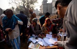 New Delhi, India - Feb. 8, 2020: Polling officials seen checking a list during Vidhan Sabha elections, at SDMC Primary School, Madanpur, in New Delhi, India, on Saturday, February 8, 2020. (Photo by Amal KS/ Hindustan Times)(Amal KS/HT PHOTO) New Delhi, India - Feb. 8, 2020: Polling officials seen checking a list during Vidhan Sabha elections, at SDMC Primary School, Madanpur, in New Delhi, India, on Saturday, February 8, 2020. (Photo by Amal KS/ Hindustan Times)(Amal KS/HT PHOTO)