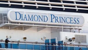 A passenger wearing a mask stands on the deck of the cruise ship Diamond Princess, at Daikoku Pier Cruise Terminal in Yokohama, south of Tokyo, on February 13.(Reuters Photo) A passenger wearing a mask stands on the deck of the cruise ship Diamond Princess, at Daikoku Pier Cruise Terminal in Yokohama, south of Tokyo, on February 13.(Reuters Photo)