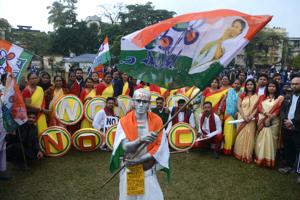 A demonstrator dressed as Mahatma Gandhi waves a flag in Siliguri.(Photo: AFP) A demonstrator dressed as Mahatma Gandhi waves a flag in Siliguri.(Photo: AFP)
