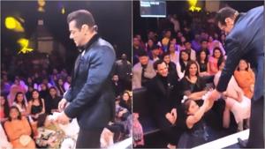 Salman Khan offering chocolates to a young girl during Bigg Boss. Salman Khan offering chocolates to a young girl during Bigg Boss.