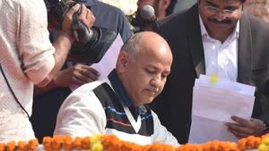 Senior Aam Aadmi Party (AAP) leader Manish Sisodia signs documents after he was sworn-in as the minister in the Delhi cabinet, at Ramlila Maidan, in New Delhi, India(Arvind Yadav/HT PHOTO) Senior Aam Aadmi Party (AAP) leader Manish Sisodia signs documents after he was sworn-in as the minister in the Delhi cabinet, at Ramlila Maidan, in New Delhi, India(Arvind Yadav/HT PHOTO)