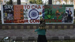 A woman walks near a protest site against Citizenship Amendment Act (CAA), NRC and NPR , at Jamia Millia Islamia University, in New Delhi, on Friday, February 14, 2020.(Burhaan Kinu/HT PHOTO) A woman walks near a protest site against Citizenship Amendment Act (CAA), NRC and NPR , at Jamia Millia Islamia University, in New Delhi, on Friday, February 14, 2020.(Burhaan Kinu/HT PHOTO)
