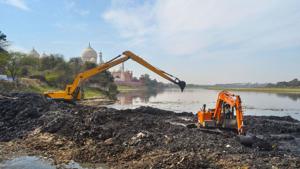 Earthmovers remove debris from the Yamuna river bed near Taj Mahal, ahead of the US President Donald Trump’s visit, in Agra, Wednesday, Feb. 19, 2020.(PTI) Earthmovers remove debris from the Yamuna river bed near Taj Mahal, ahead of the US President Donald Trump’s visit, in Agra, Wednesday, Feb. 19, 2020.(PTI)