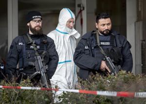 German police officers guard the entrance of a bar where several people were killed late Wednesday in Hanau, Germany.(AP Photo) German police officers guard the entrance of a bar where several people were killed late Wednesday in Hanau, Germany.(AP Photo)