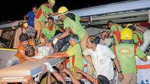 Rescue personnel and volunteers help the injured passengers after a bus accident in Tamil Nadu’s Tirupur district on Thursday.(PTI) Rescue personnel and volunteers help the injured passengers after a bus accident in Tamil Nadu’s Tirupur district on Thursday.(PTI)