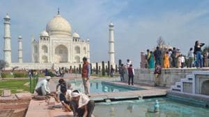 Agra: Workers fix tiles near the fountains at Taj Mahal, ahead of US President Donald Trump's visit, in Agra(PTI)