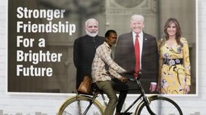 A man rides his cycle past a hoarding with the images of PM Narendra Modi, Donald Trump and first lady Melania Trump ahead of US president’s visit, in Ahmedabad, India, February 22, 2020.(Reuters photo) A man rides his cycle past a hoarding with the images of PM Narendra Modi, Donald Trump and first lady Melania Trump ahead of US president’s visit, in Ahmedabad, India, February 22, 2020.(Reuters photo)
