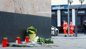 Flowers and candles are placed near the Midnight Shisha bar after a shooting in Hanau, near Frankfurt, Germany.(REUTERS) Flowers and candles are placed near the Midnight Shisha bar after a shooting in Hanau, near Frankfurt, Germany.(REUTERS)