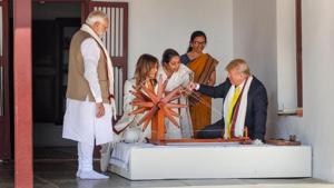 US President Donald Trump tries spinning on a traditional 'charkha' at Sabarmati Ashram in Ahmedabad on Monday.(PTI PHOTO.) US President Donald Trump tries spinning on a traditional 'charkha' at Sabarmati Ashram in Ahmedabad on Monday.(PTI PHOTO.)