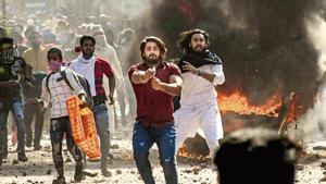 A protestor brandishes a pistol during clashes between a group of anti-CAA protestors and supporters of the new citizenship act, at Jafrabad in north-east Delhi.(PTI photo) A protestor brandishes a pistol during clashes between a group of anti-CAA protestors and supporters of the new citizenship act, at Jafrabad in north-east Delhi.(PTI photo)