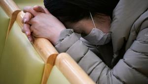 A christian faithful wearing a mask to prevent contacting coronavirus prays during a service in Seoul, South Korea.(Reuters File Photo)