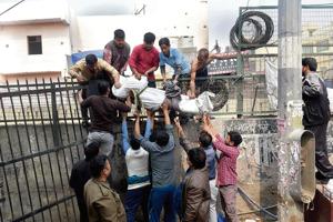 People retrieve the body of 26-year-old Ankit Sharma, an IB staffer, from a riot-affected area in north-east Delhi, on Wednesday.(Photo: PTI) People retrieve the body of 26-year-old Ankit Sharma, an IB staffer, from a riot-affected area in north-east Delhi, on Wednesday.(Photo: PTI)