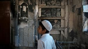 An Indian Muslim boy stands inside a mosque burnt in Tuesday's violence in New Delhi, India, Thursday, Feb. 27, 2020.(AP photo)
