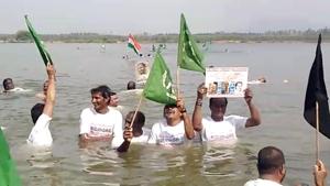 People hold flags as they protest against Andhra Pradesh government’s decision of decentralisation, in the water of Krishna river in Amaravati last month.(ANI Photo) People hold flags as they protest against Andhra Pradesh government’s decision of decentralisation, in the water of Krishna river in Amaravati last month.(ANI Photo)